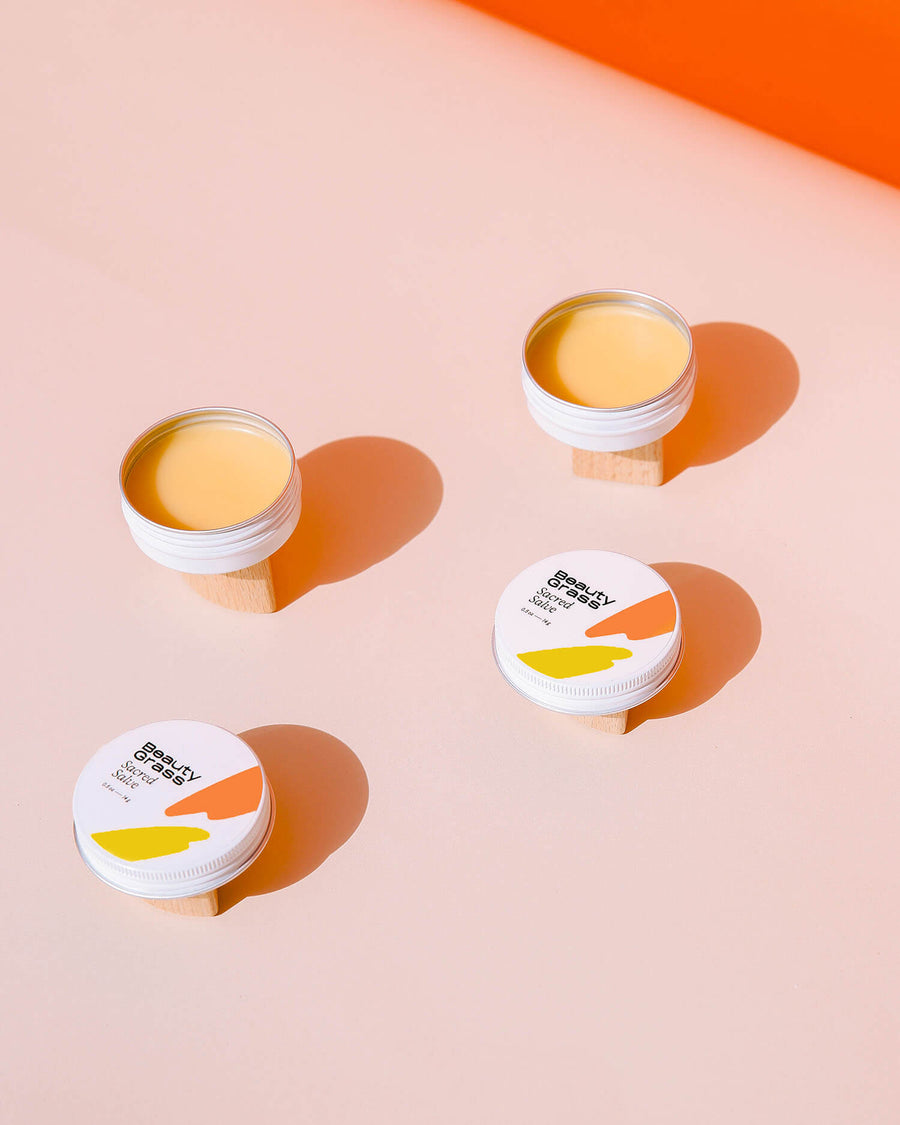 Ultra-healing skin salve, Sacred Salve, on orange background